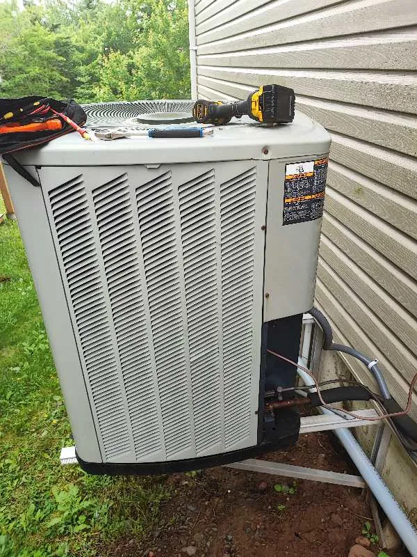 Air conditioning condenser and electrical disconnect installed in a side yard