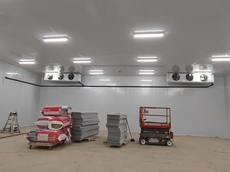 Ceiling-mounted evaporator units installed in a new commercial walk-in cooler room